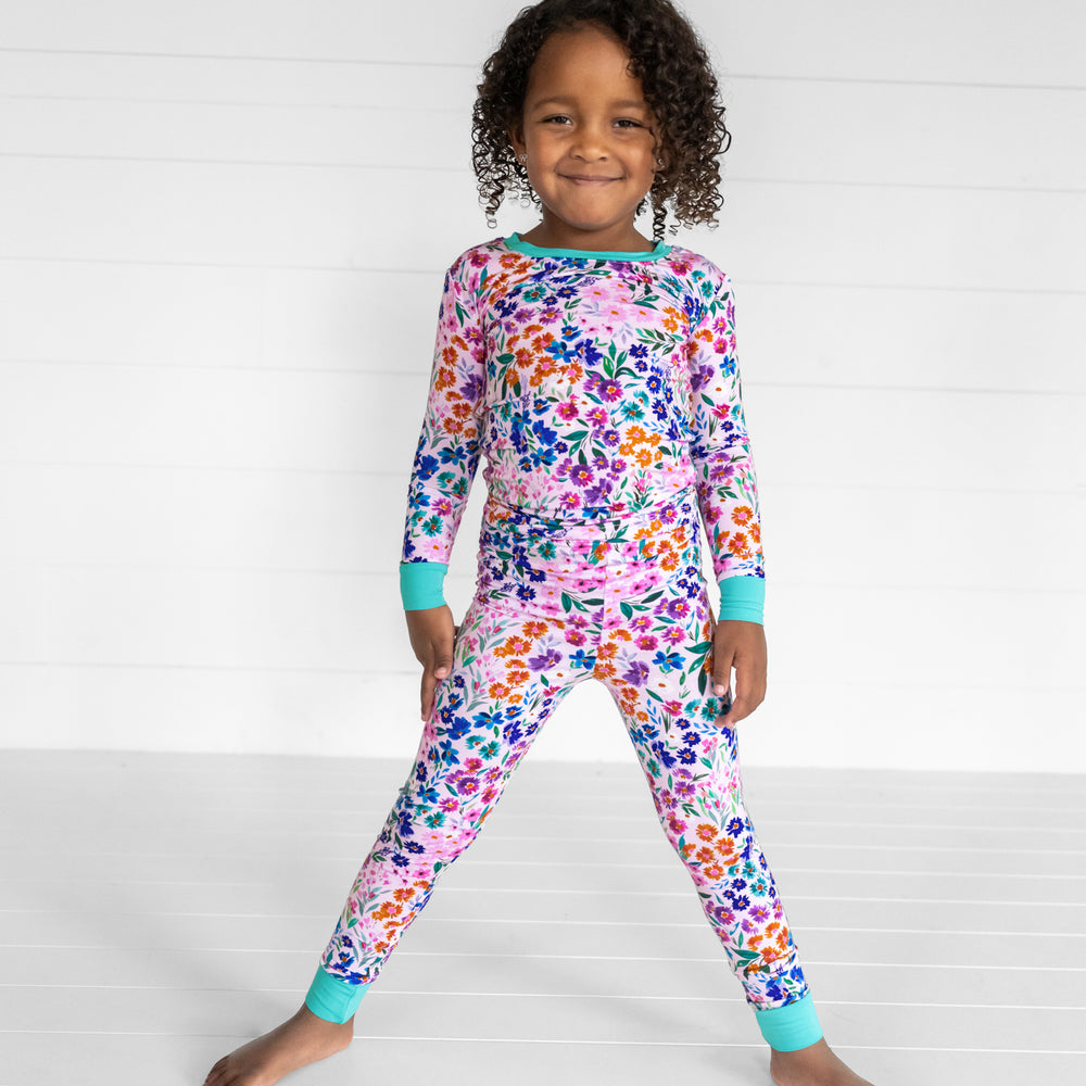 Image of a child posing wearing a Sweet Pea floral two piece pj set