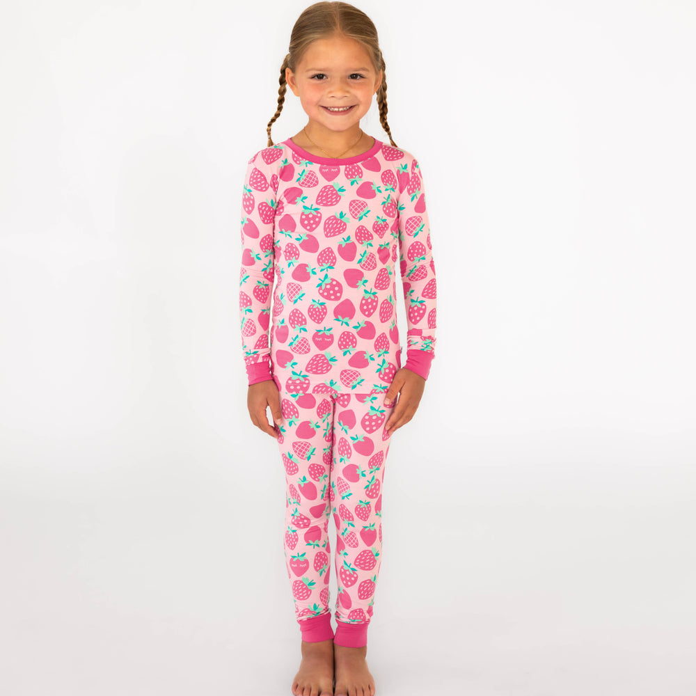 Girl standing while wearing the Sweet Strawberries Two-Piece Pajama Set