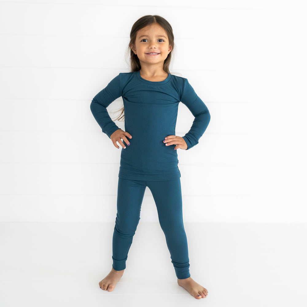 Child posing wearing a Cozy Twilight Teal two piece pj set