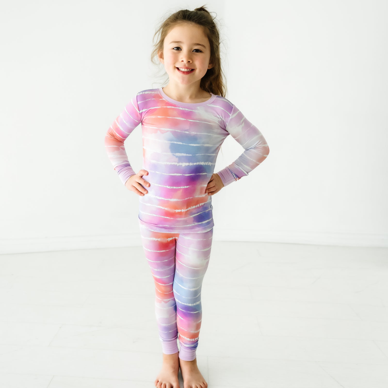 Child wearing a Pastel Tie Dye Dreams two-piece pajama set