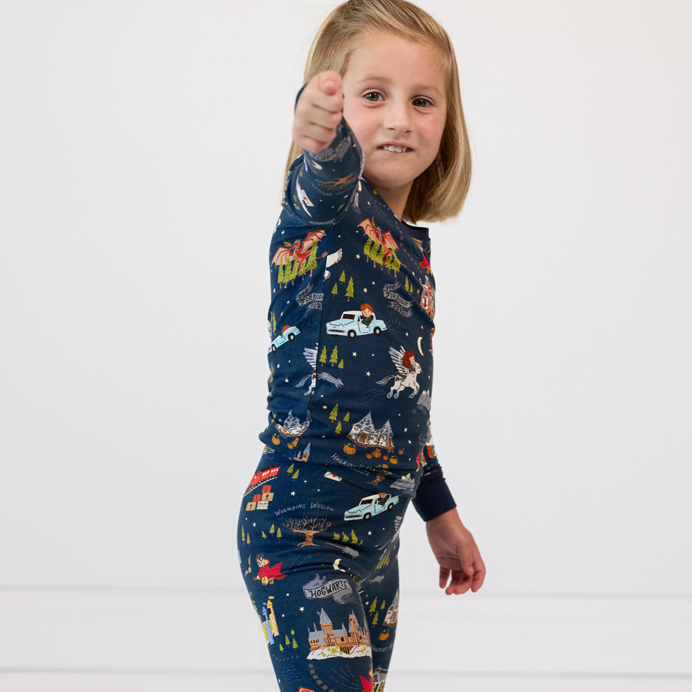 Child posing with an imaginary wand wearing An Evening at Hogwarts two piece pj set