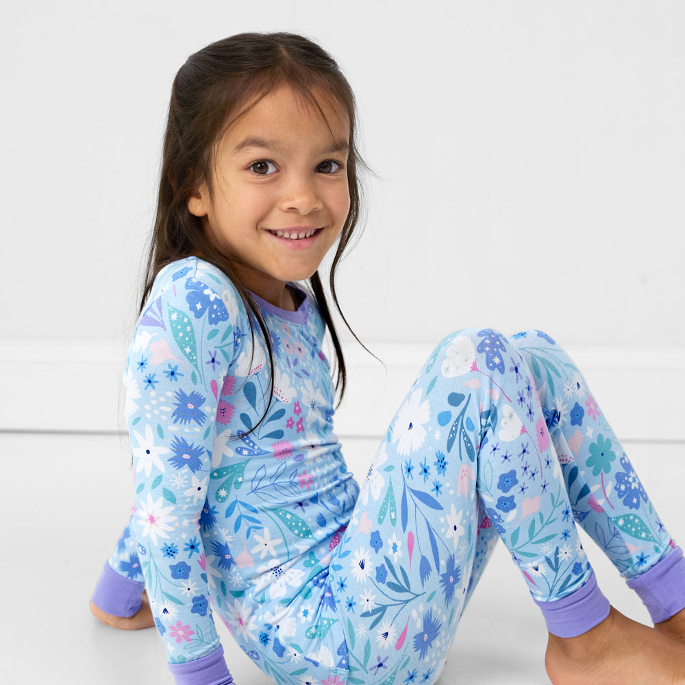 image of a child sitting wearing a Magical Meadow two piece pj set