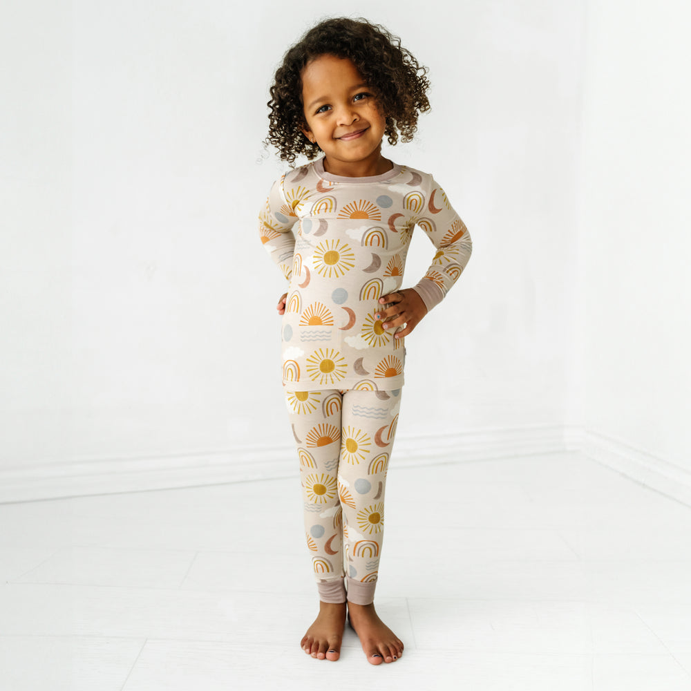 Child posing wearing Desert Sunrise two piece pajama set