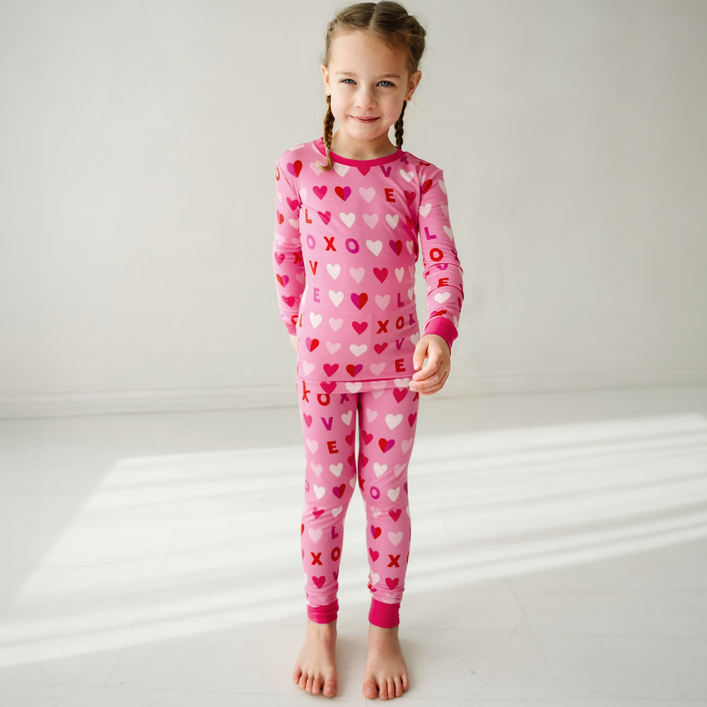 Click to see full screen - Child posing wearing Pink XOXO two piece pajama set