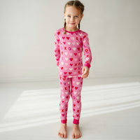 Child posing wearing Pink XOXO two piece pajama set