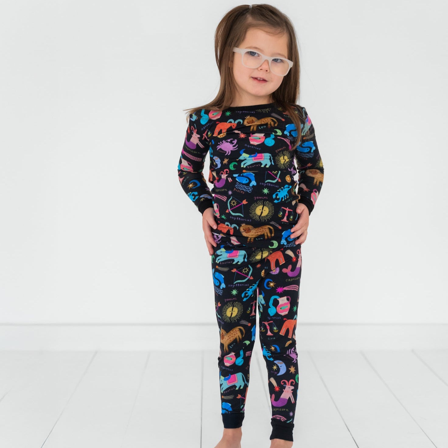 Child posing wearing a Star Signs two piece pajama set