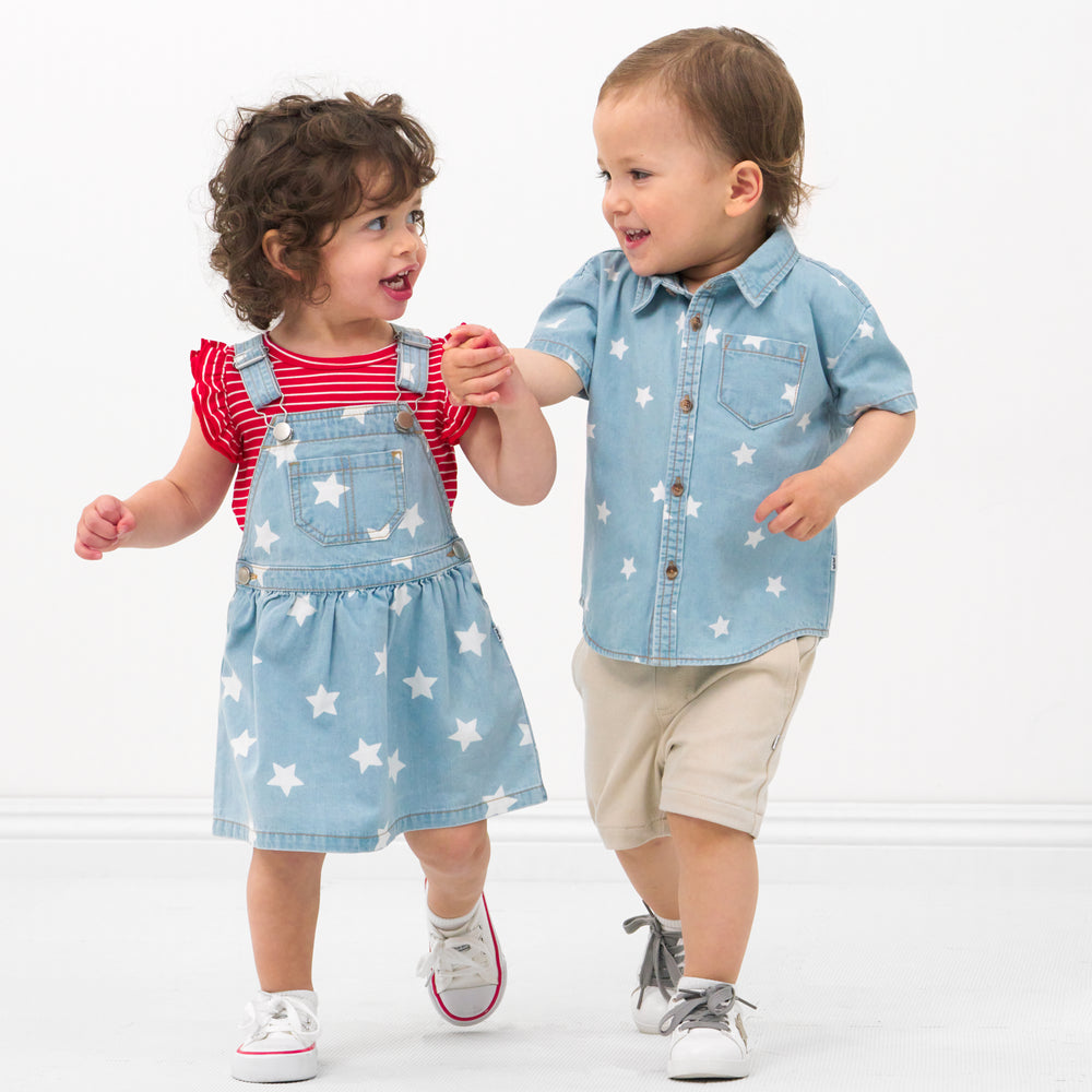 Two children holding hands wearing coordinating 4th of July Play outfits