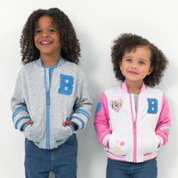 Boy wearing the Bluey Blue Bomber Jacket and girl wearing the Bluey Pink Bomber Jacket 