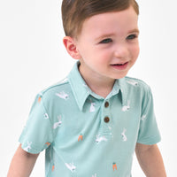 Close up image of a child wearing a Bunny Hops polo shirt