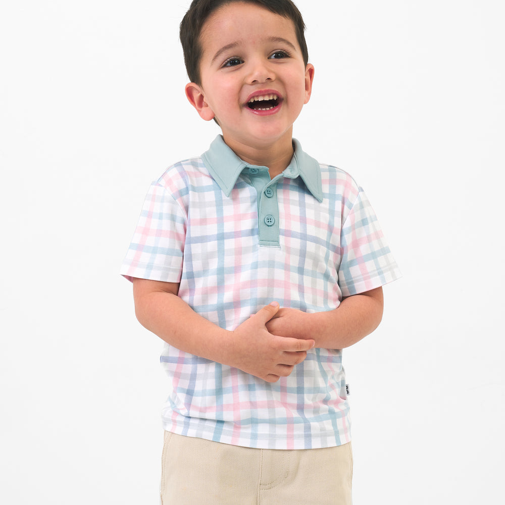 Child wearing a Playful Plaid polo shirt and coordinating chino shorts