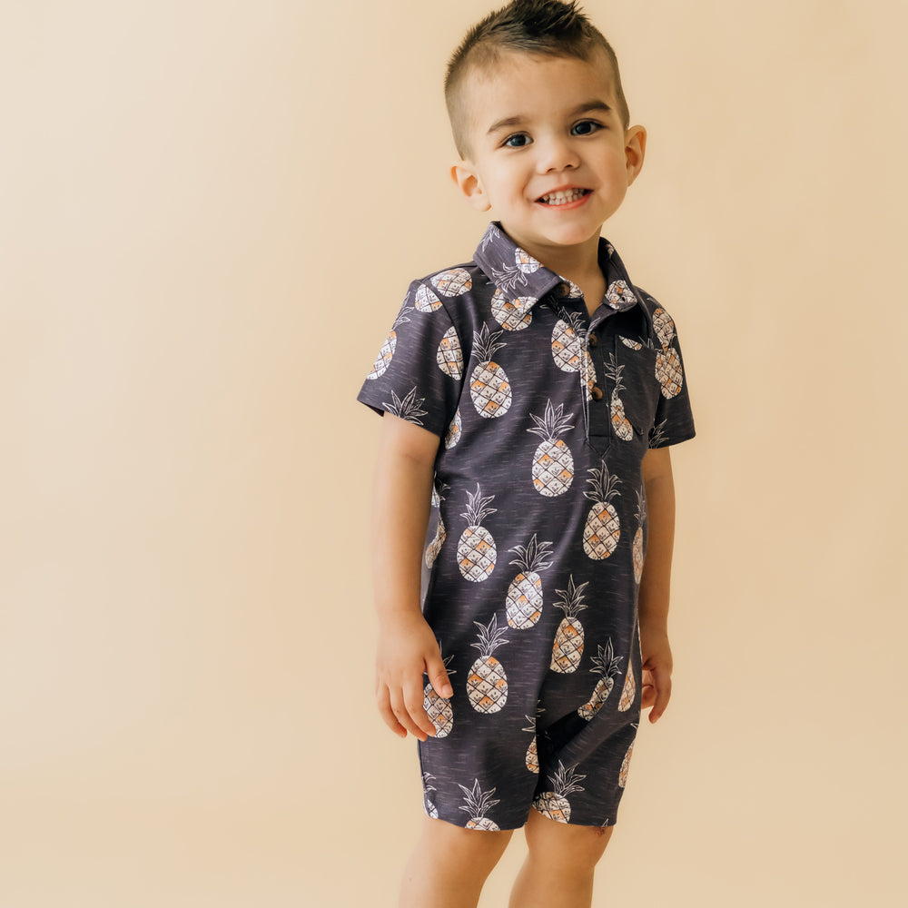 child posing wearing Sweet Paradise polo shorty romper