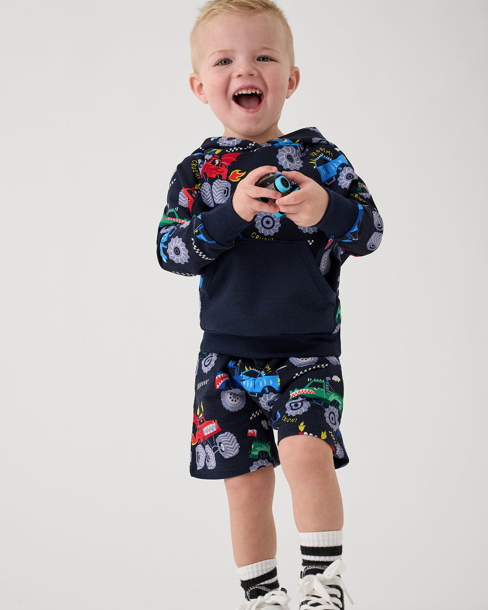 Child wearing the Monster Truck Madness Hoodie and Drawstring Shorts