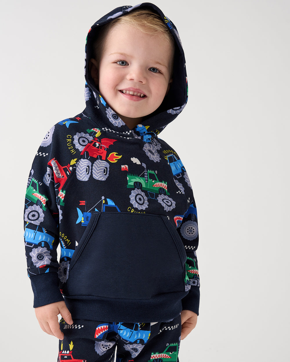 Boy wearing the Monster Truck Madness Pullover Hoodie with the hood on