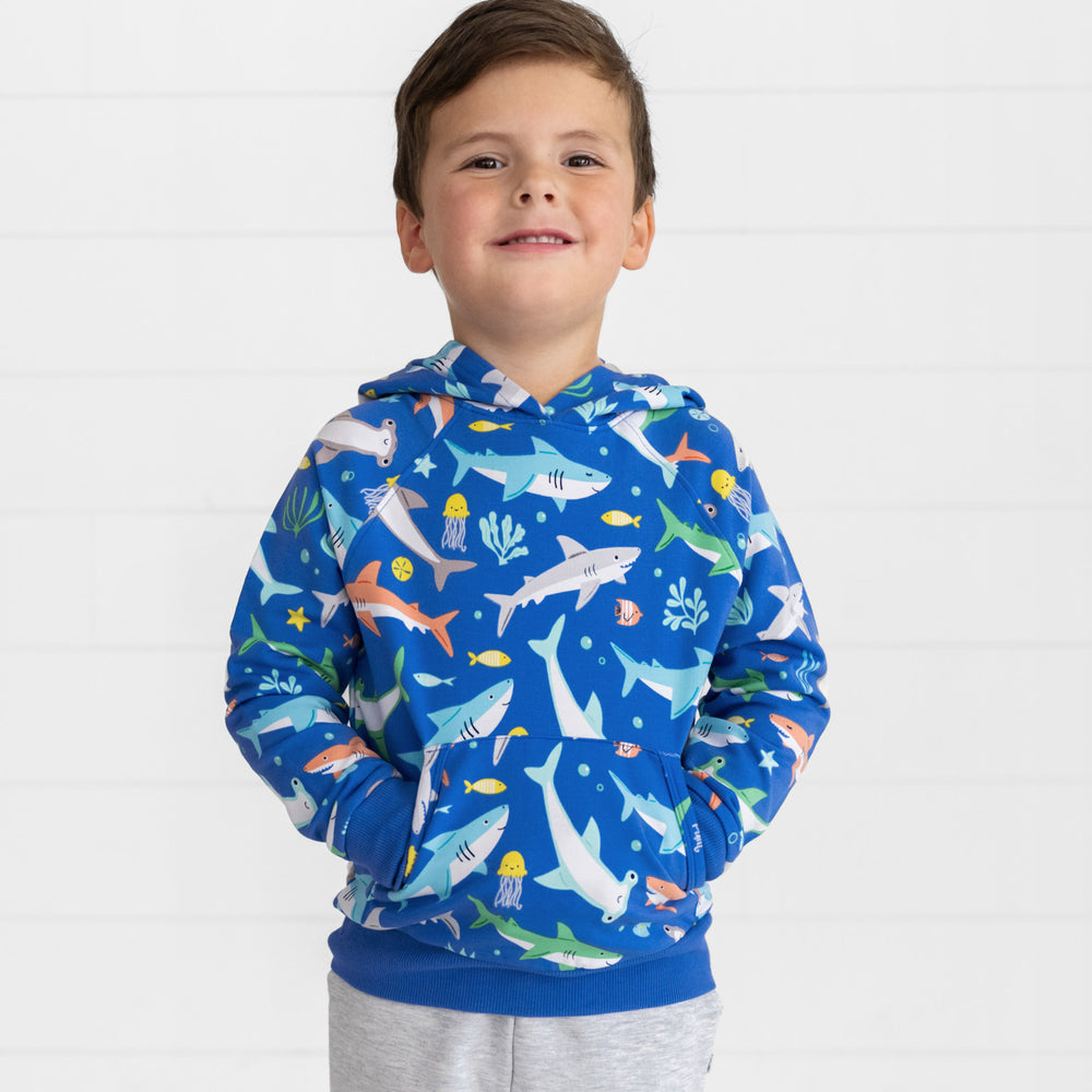 Boy posing with hands in the front pocket of the Rad Reef Pullover Hoodie