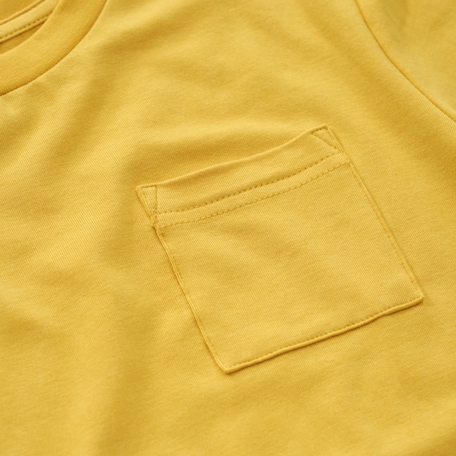 Close up image of the pocket detail on the Honey Relaxed Pocket Tee 