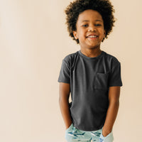 Child wearing a Washed Black relaxed pocket tee