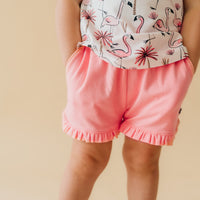 Alternate close up image of a child wearing Coral ruffle shorts