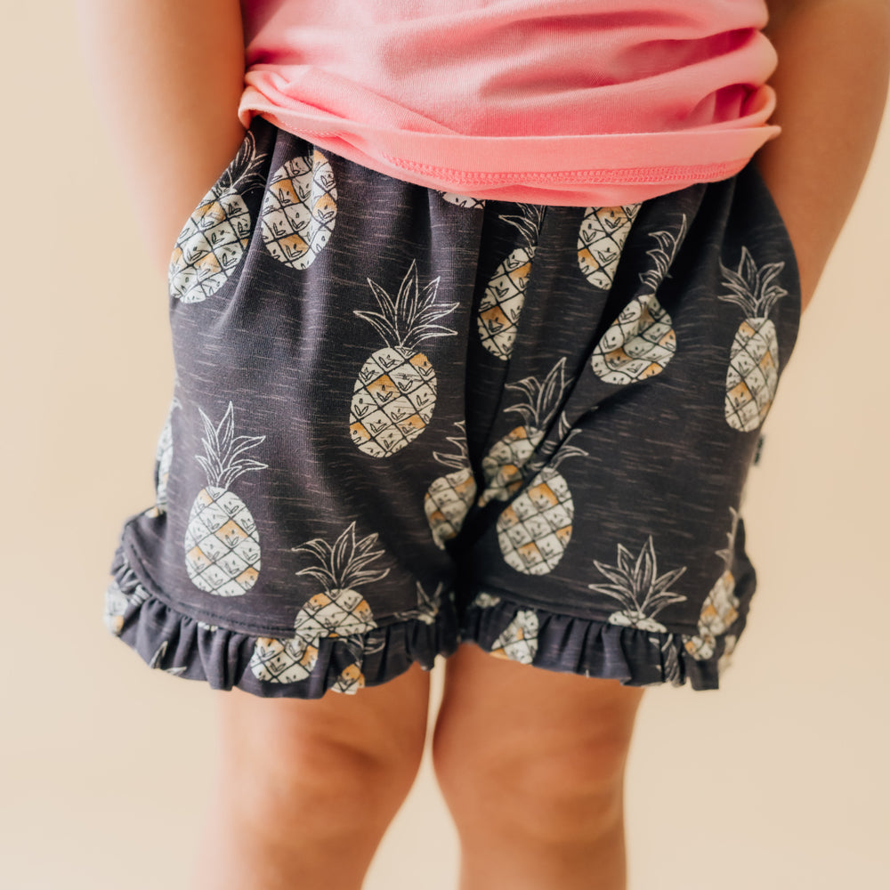 Close up image of a child wearing Sweet Paradise ruffle shorts