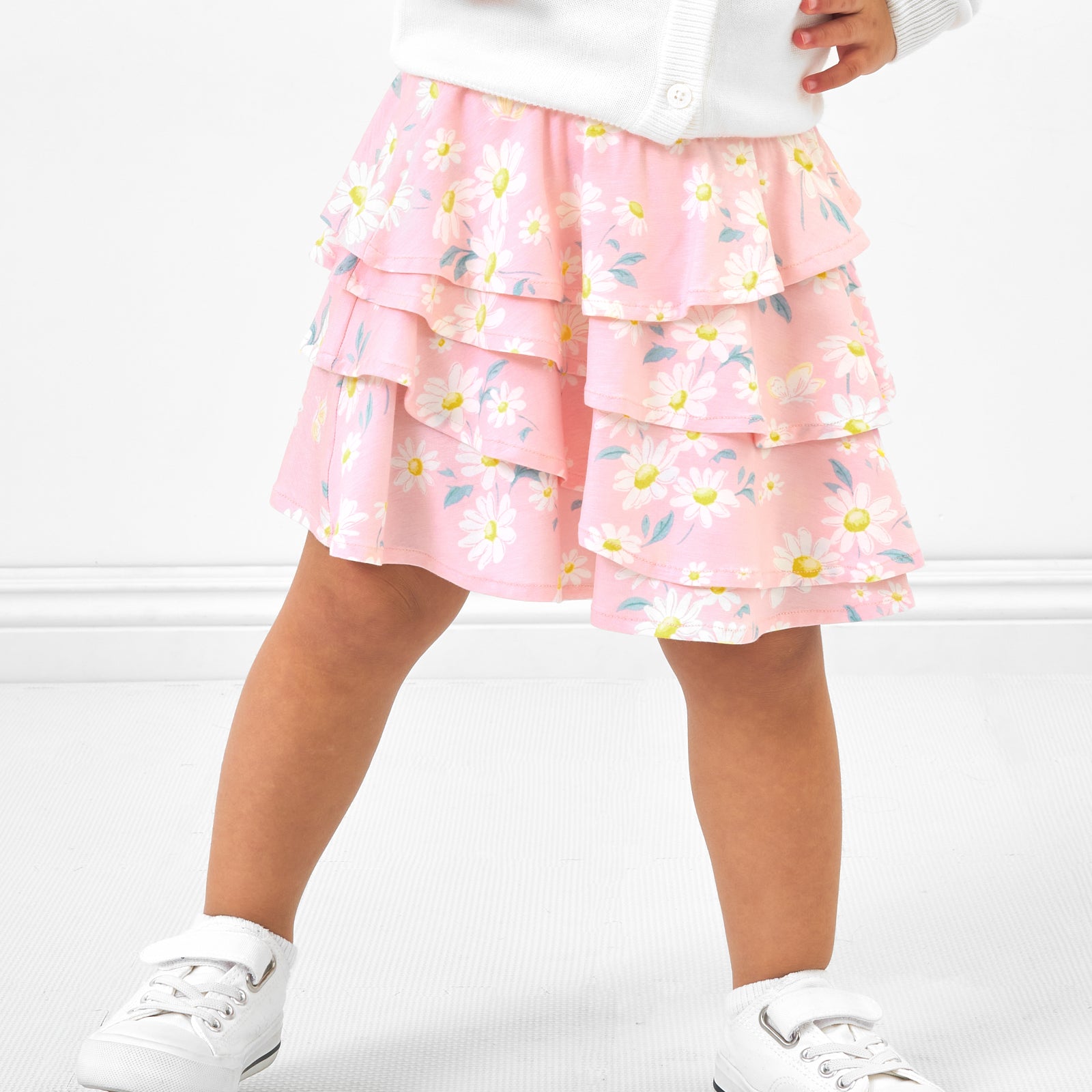 Close up image of a child wearing a Rosy Meadow ruffle skort
