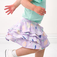 profile view of a child wearing a Sandy Treasures ruffle skort