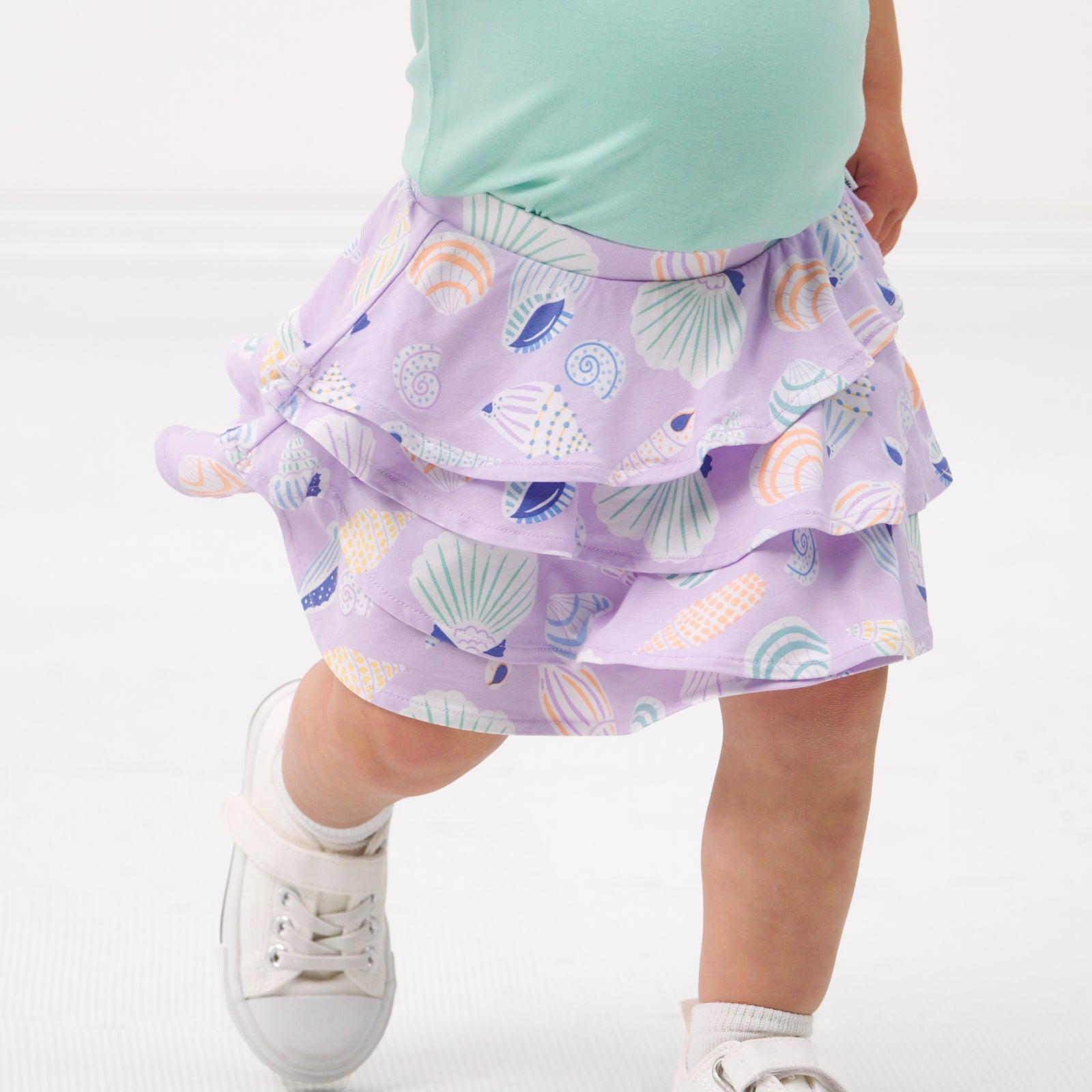 Close up image of a child wearing a Sandy Treasures ruffle skort