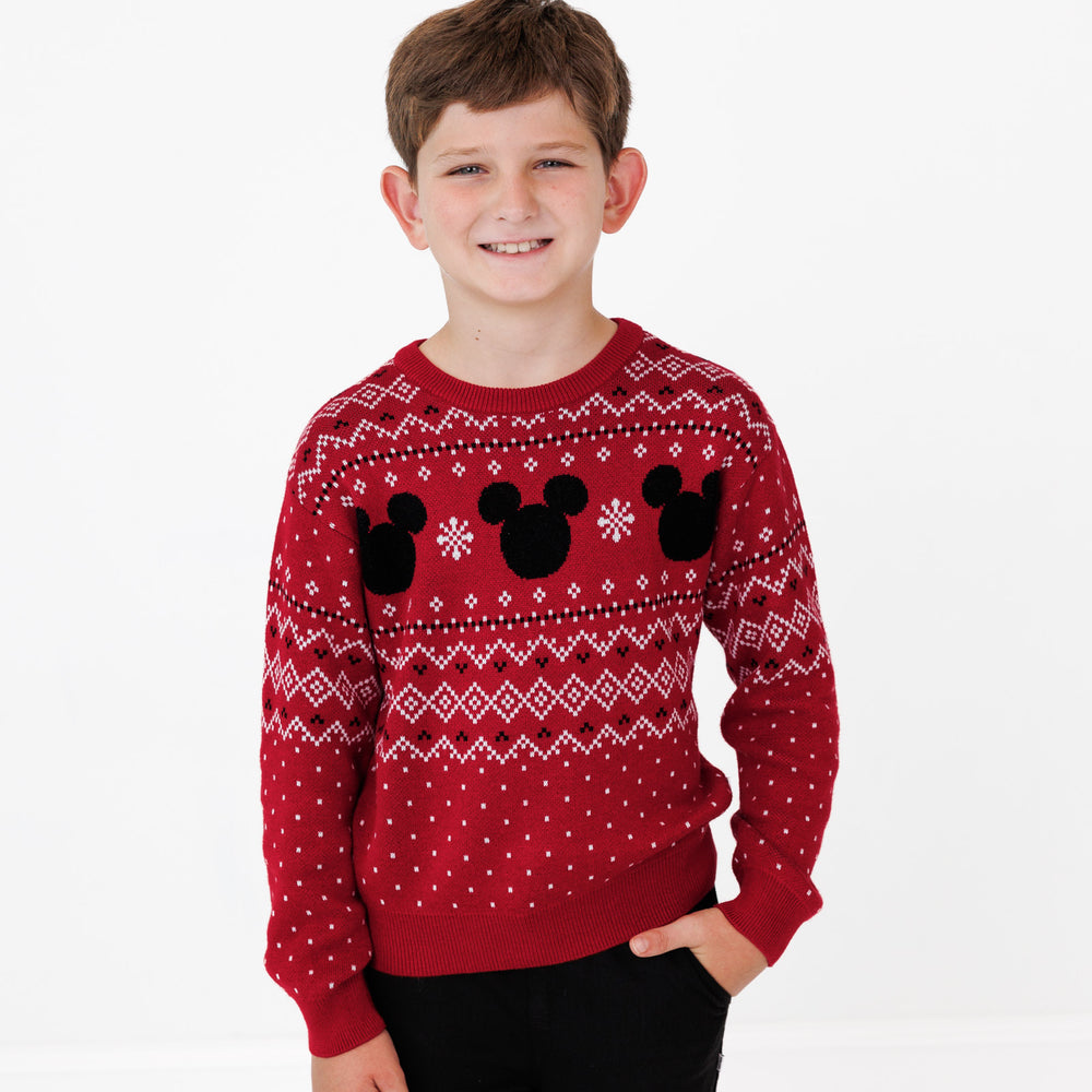 Close up image of a child wearing a Vintage Mickey Fair Isle Relaxed Sweater and Black Denim Jogger