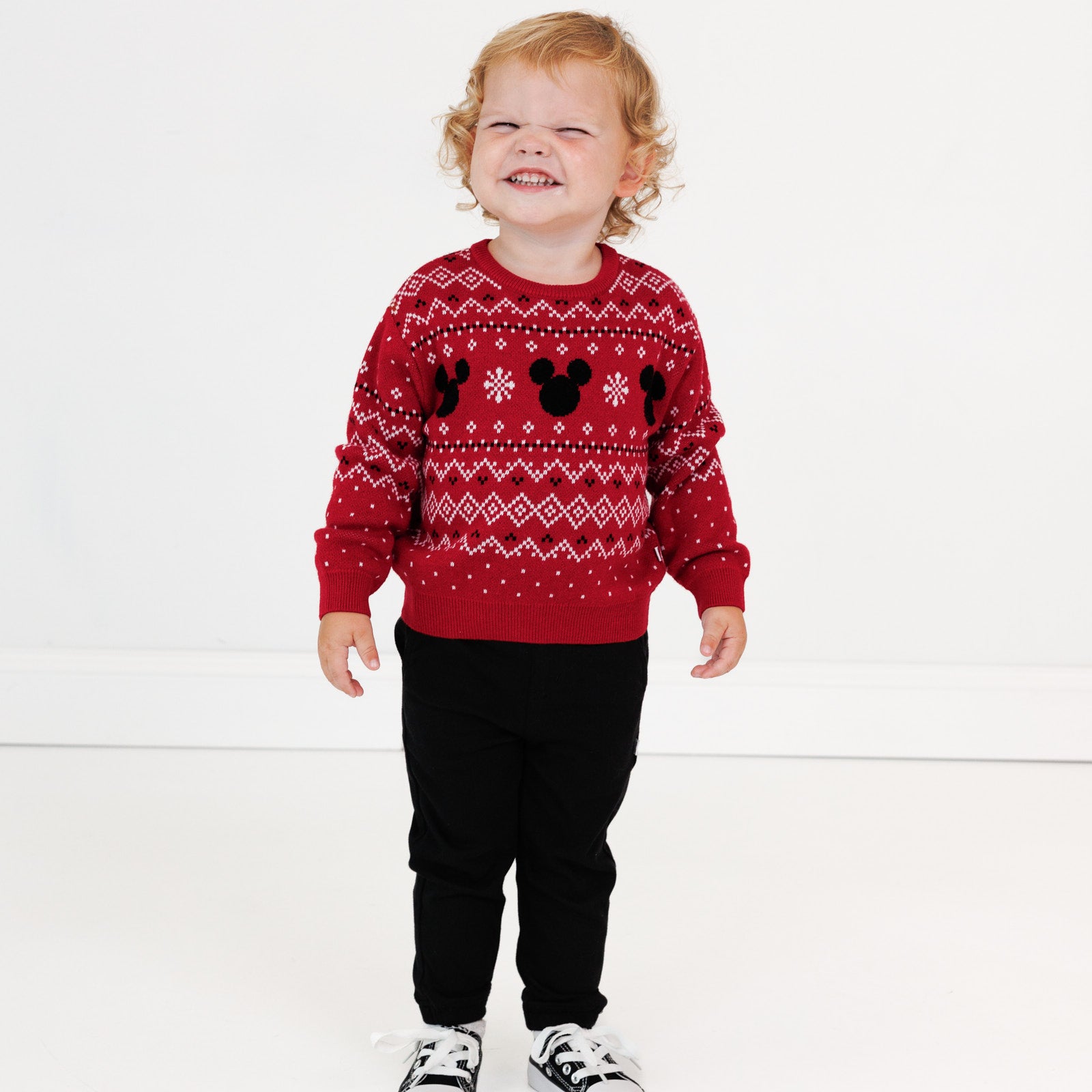 Image of a child wearing a Vintage Mickey Fair Isle Relaxed Sweater and Black Denim Jogger