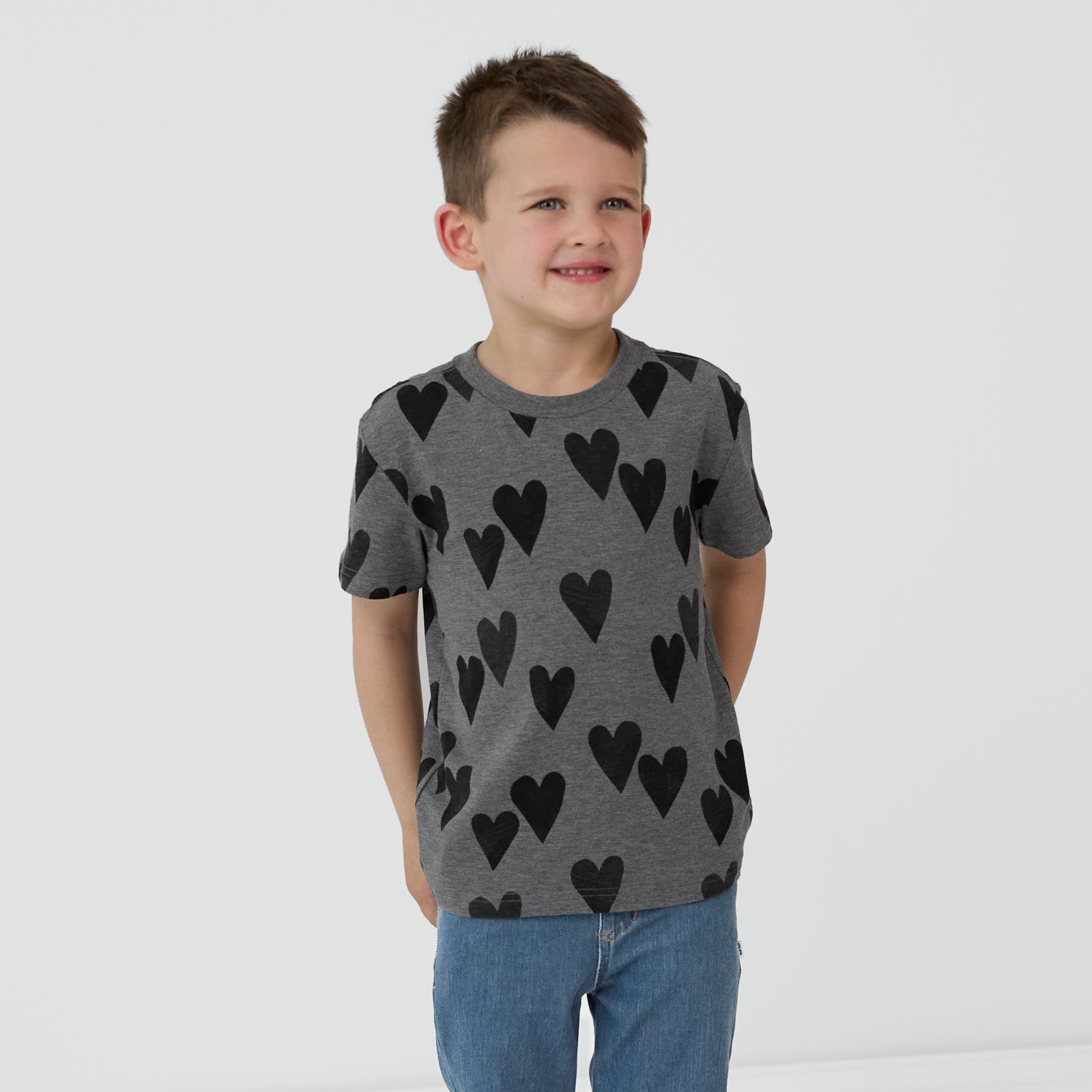 Child with their hands in their back pockets wearing a Heather Hearts Relaxed Tee and coordinating denim jogger