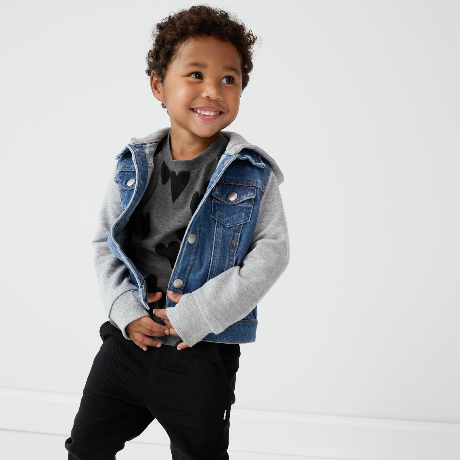 Child wearing a Heather Hearts Relaxed Tee layered with a Midwash Blue Denim Jacket and coordinating denim jogger