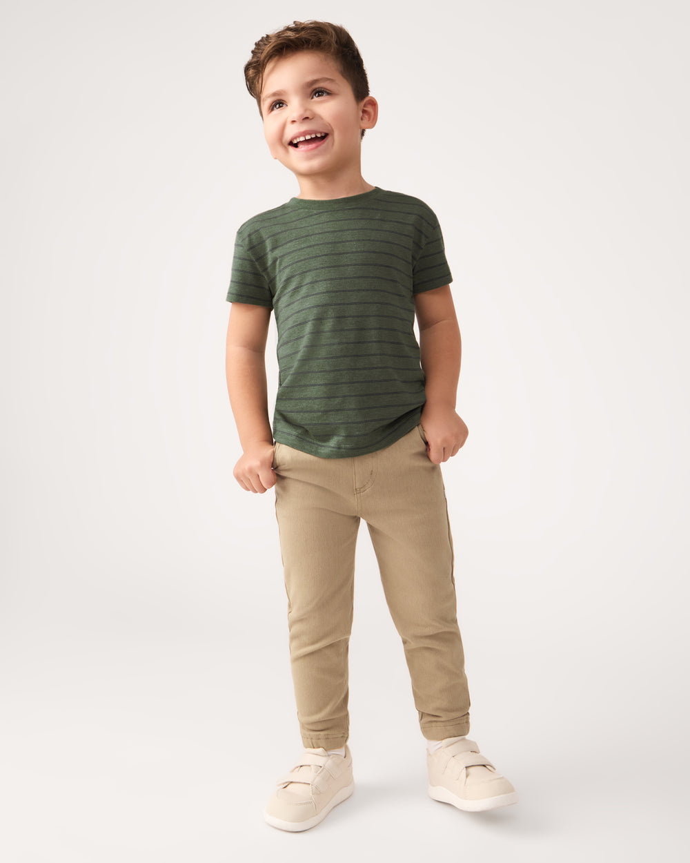 Standing boy wearing the Olive Stripes Short Sleeve Relaxed Tee with khaki joggers