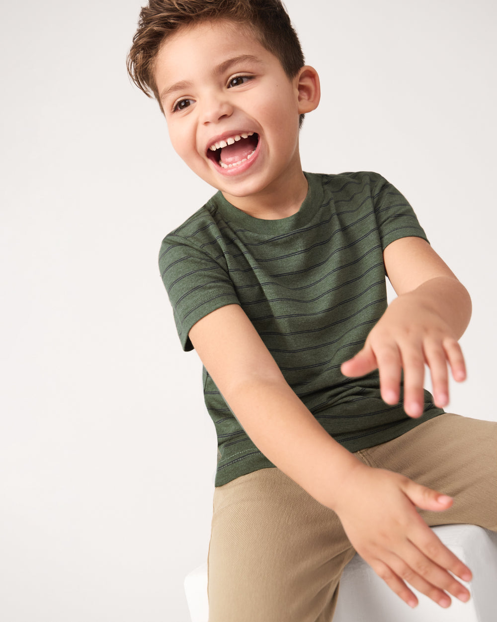 Child in motion wearing the Olive Stripes Short Sleeve Relaxed Tee