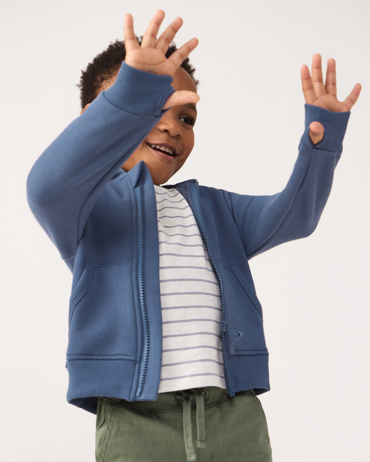 Child showing the thumb holes on the Vintage Navy Zip Hoodie