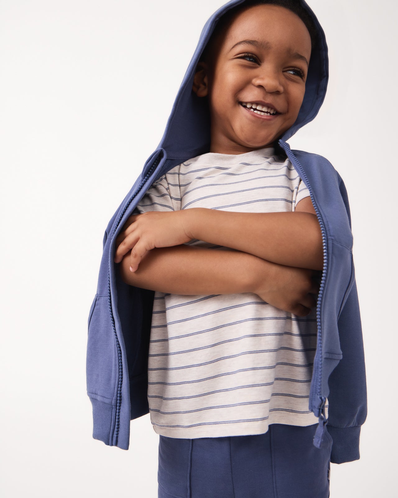 Boy wearing the Stone Stripes Short Sleeve Relaxed Tee under a navy hoodie