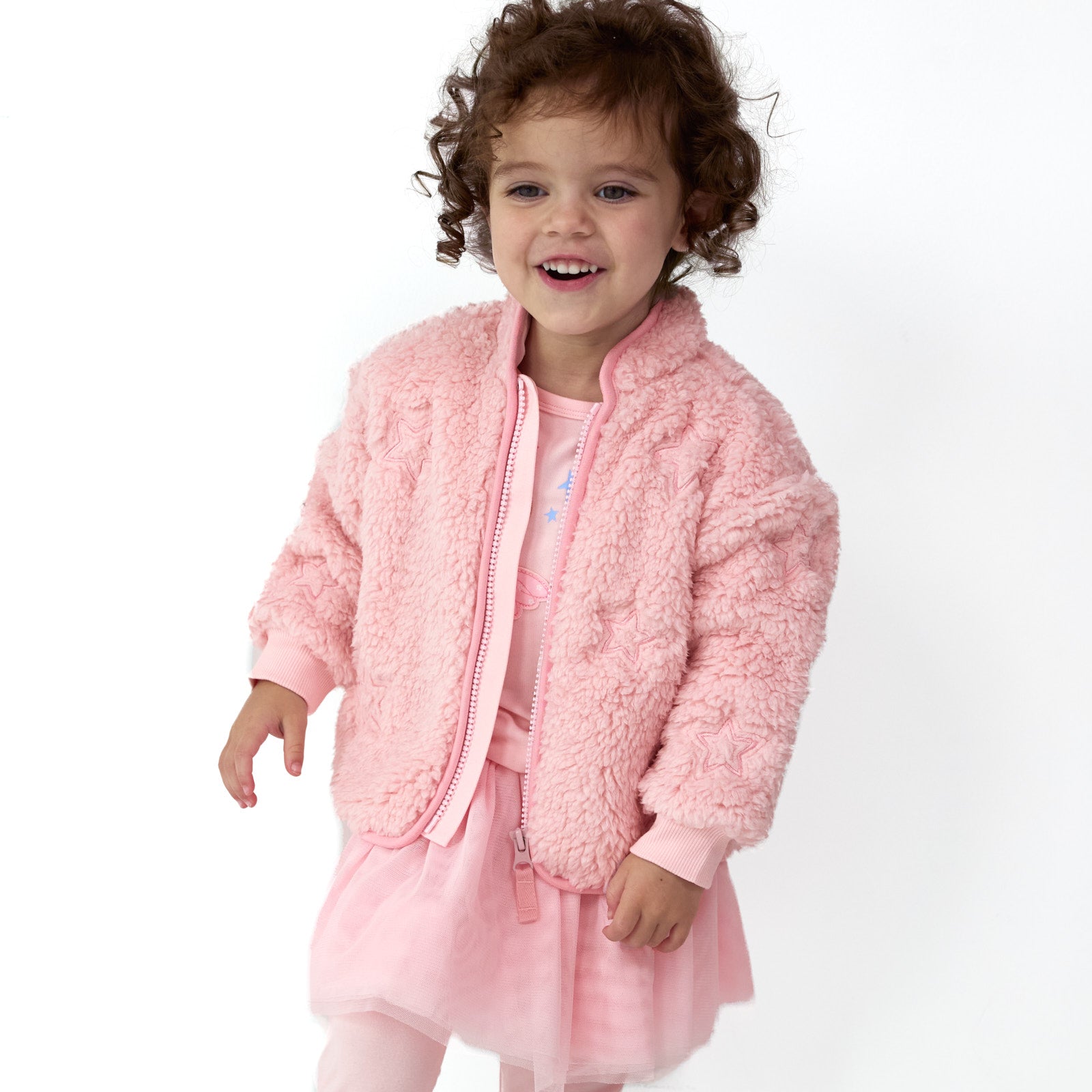 Smiling girl wearing the Prima Pink Sherpa Zip Jacket over the Prima Pink Tutu Legging and Prima Pink Flutter Tee