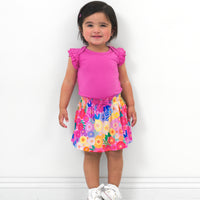 Child wearing a Rainbow Blooms skort and coordinating top