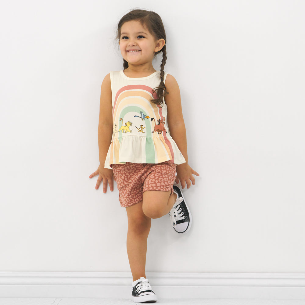Child wearing a Lion King graphic peplum tank and coordinating Play shorts