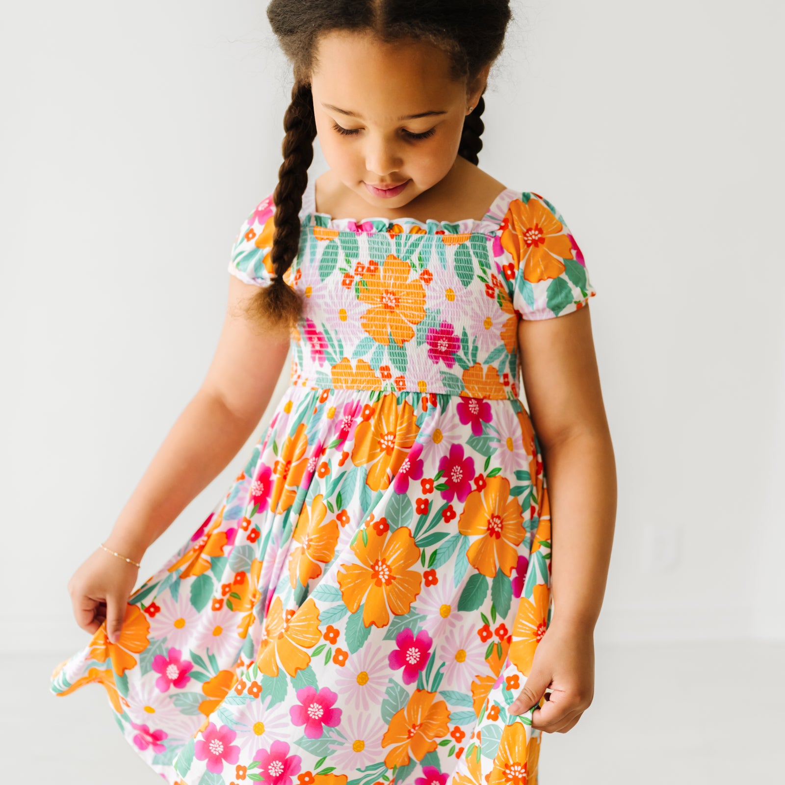 Alternate close up image of a child wearing a Beachy Blooms puff sleeve smocked dress