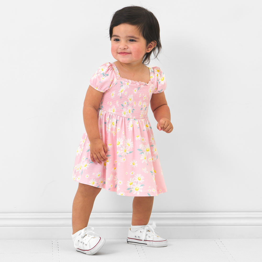 Child wearing a Rosy Meadow puff sleeve smocked dress with bloomer