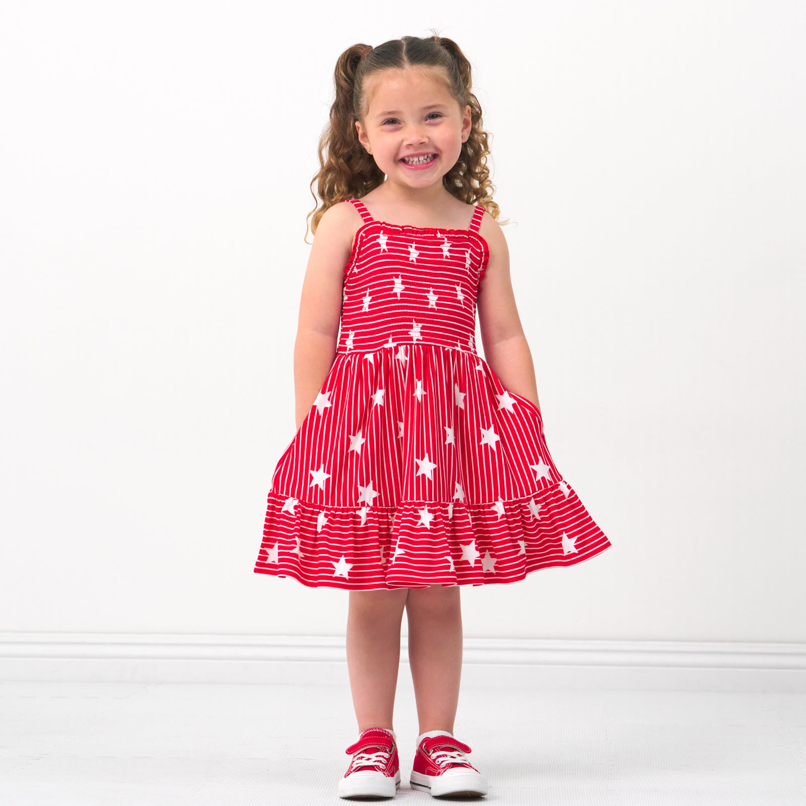 Child wearing a Stripes & Sparkles tank smocked dress