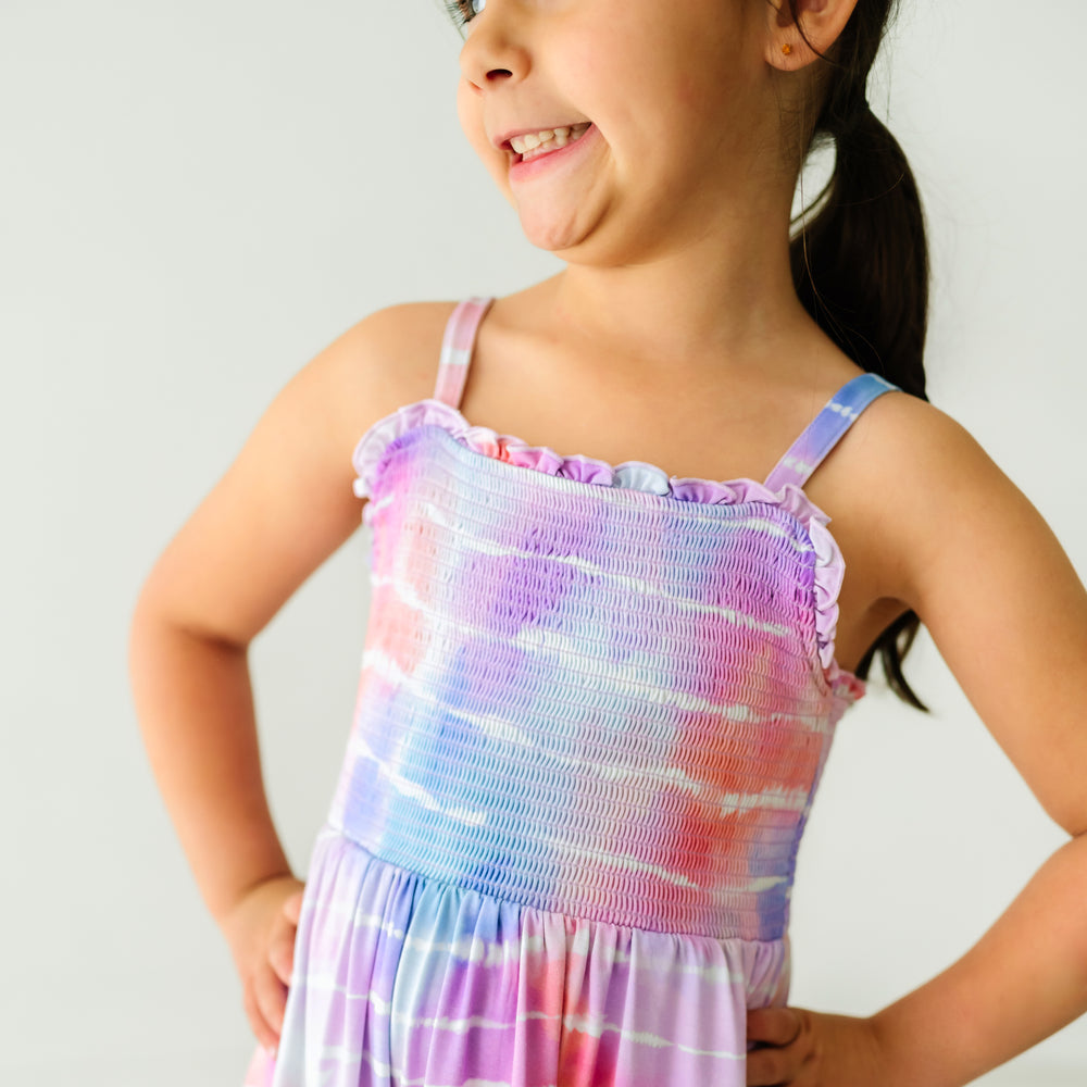 Close up image of a child wearing a Pastel Tie Dye Dreams tank smocked dress