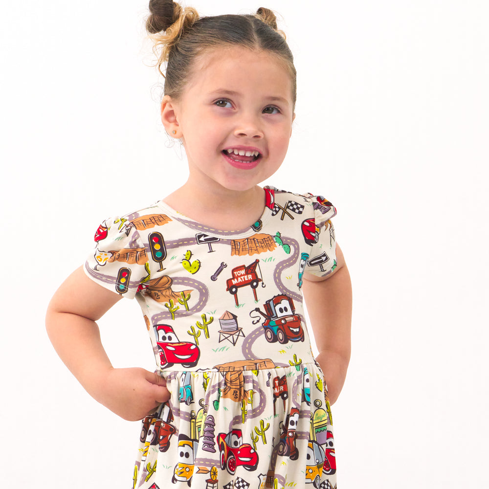 Close up image of a child wearing a Radiator Springs skater dress