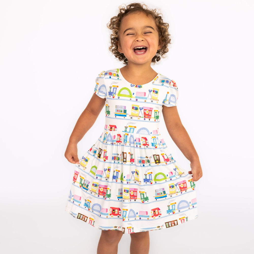 Girl standing and showing the Education Express Skater Dress