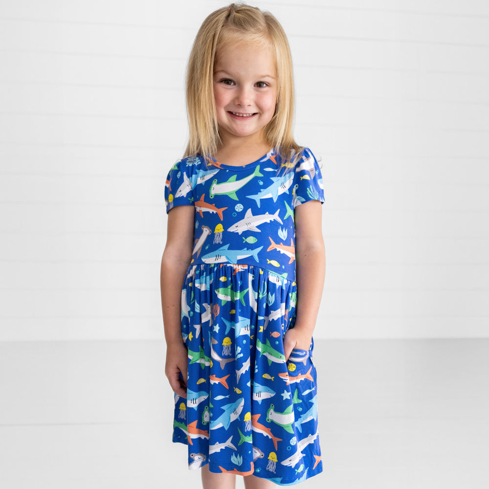 Smiling girl posing with hand in the pocket of the Rad Reef Skater Dress