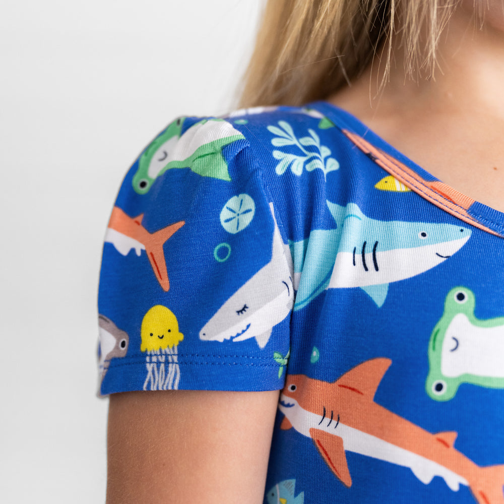 Close up image of girl waring the Rad Reef Skater Dress, displaying the shoulder snd graphics detail on the Rad Reef Skater Dress