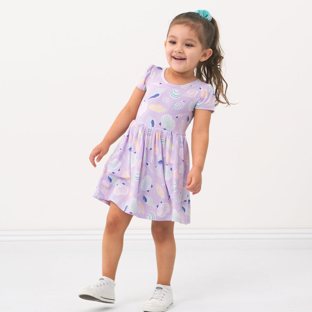 Child posing wearing a Sandy Treasures twirl dress