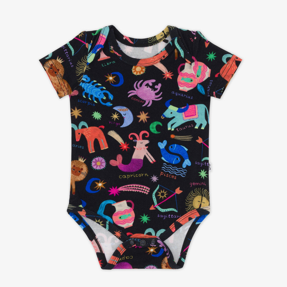 flat lay of a star signs bodysuit featuring multicolored drawings of the zodiac signs on a black background