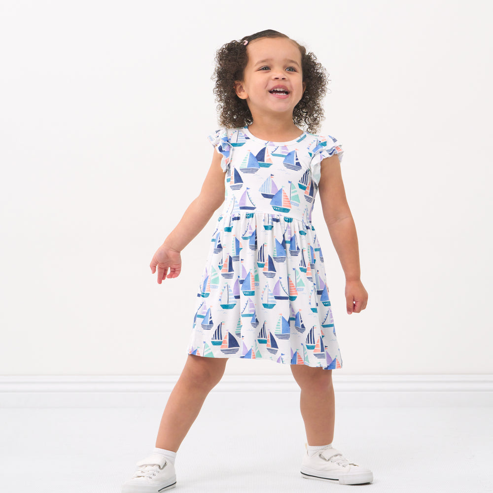 Child posing wearing a Seas the Day flutter Skater Dress