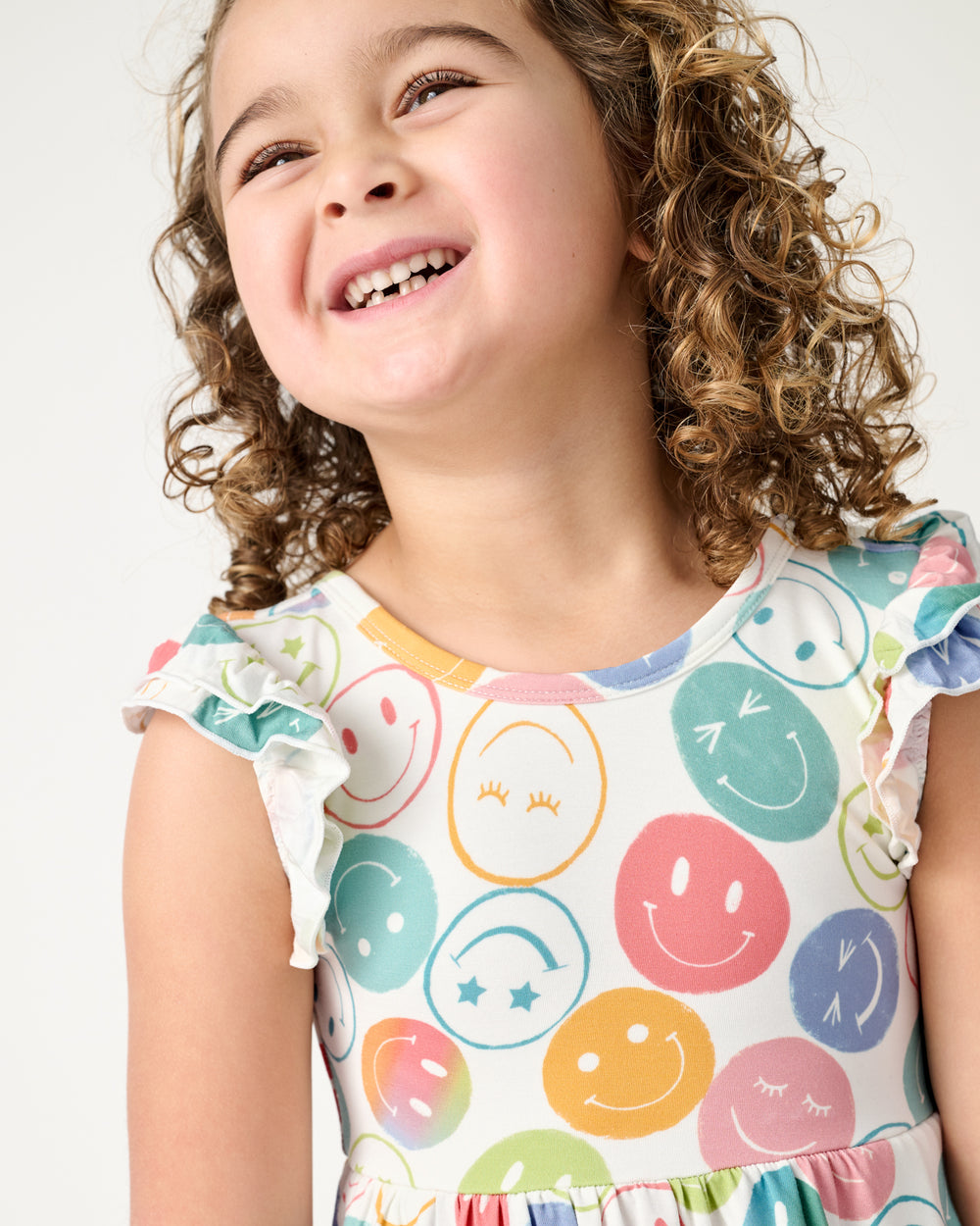 Close up of girl wearing the Positive Vibes Flutter Twirl Dress