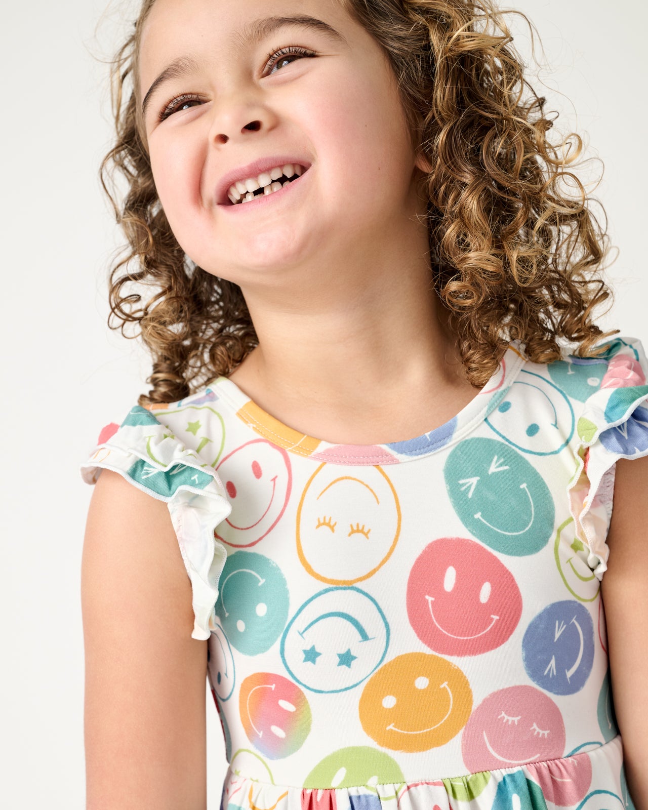 Close up of girl wearing the Positive Vibes Flutter Twirl Dress