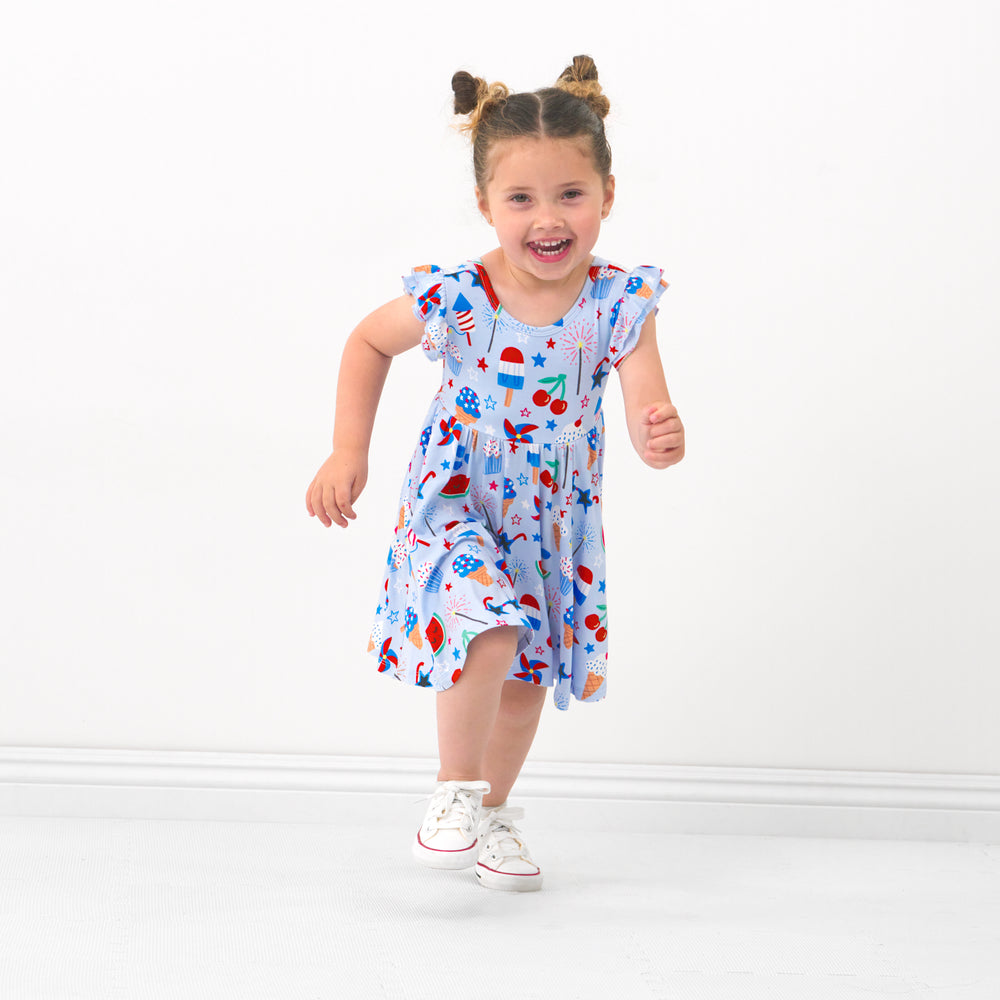 Child running wearing a Stars, Stripes & Sweets flutter twirl dress